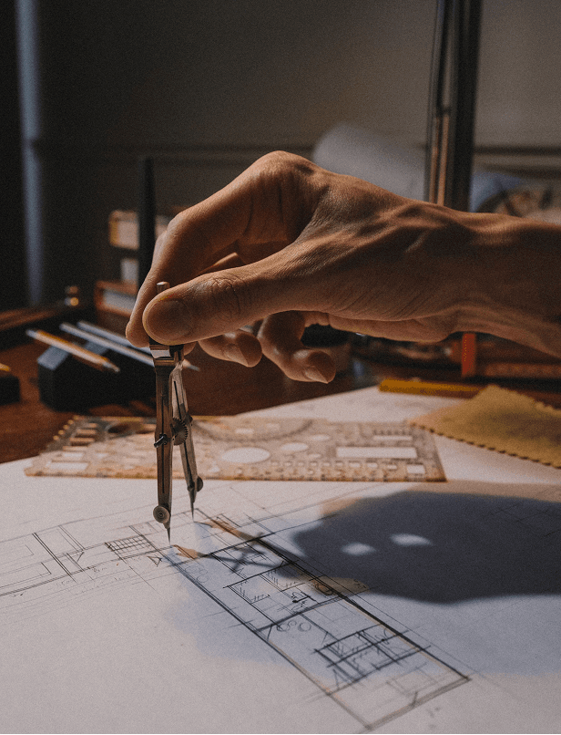Architect reviewing construction plans at a work table